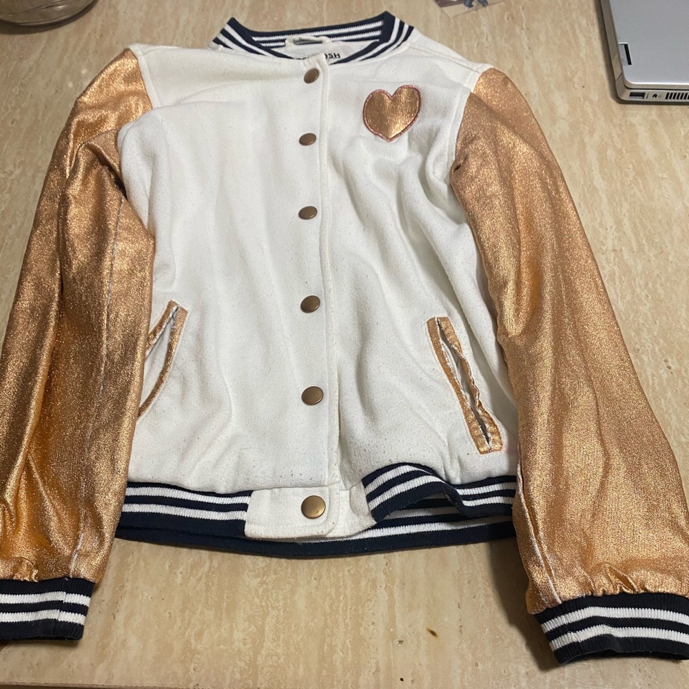A shiny gold and white sweater
